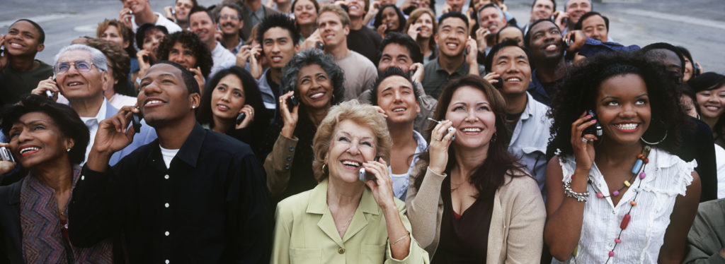 a group of multicultural people smiling and looking up