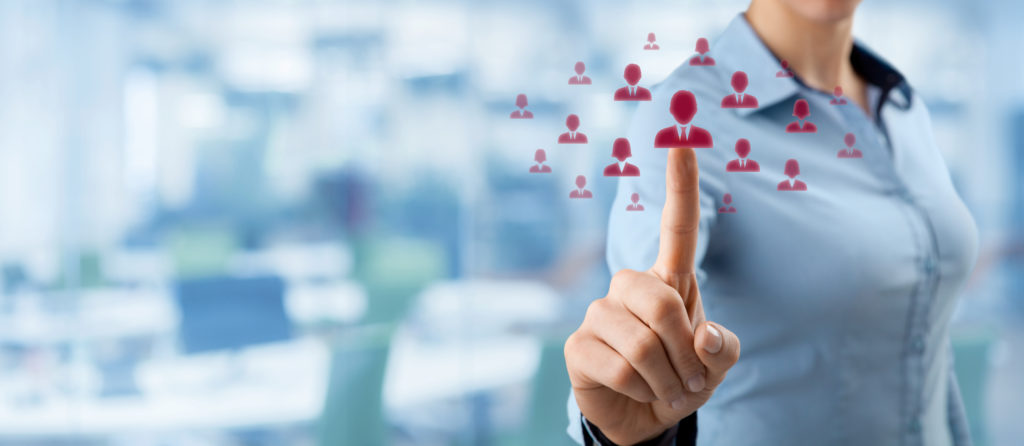 a female employee placing her finger over an array of digital representations of employees